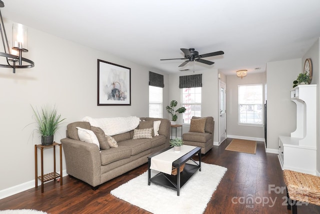 living room featuring ceiling fan and dark wood-type flooring