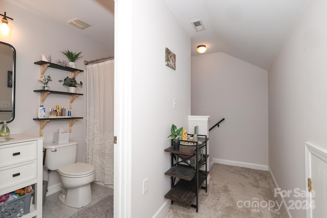 bathroom featuring curtained shower, vanity, and toilet