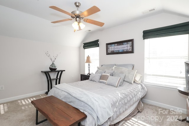 bedroom featuring ceiling fan, lofted ceiling, light carpet, and multiple windows