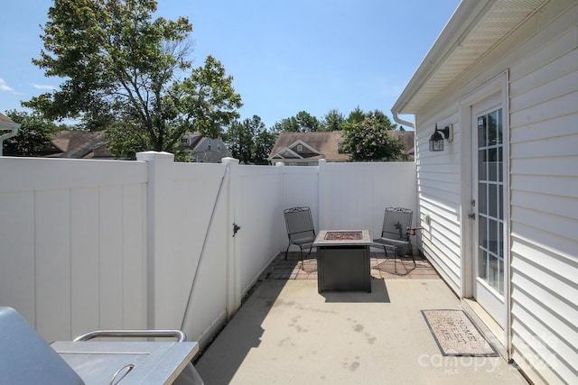 view of patio with a fire pit