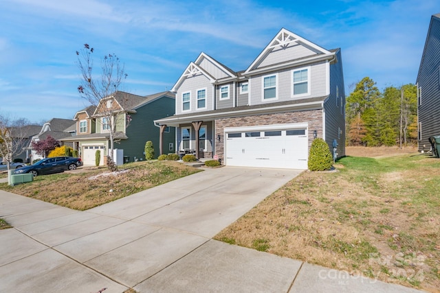 view of front of home featuring a front yard, a porch, and a garage