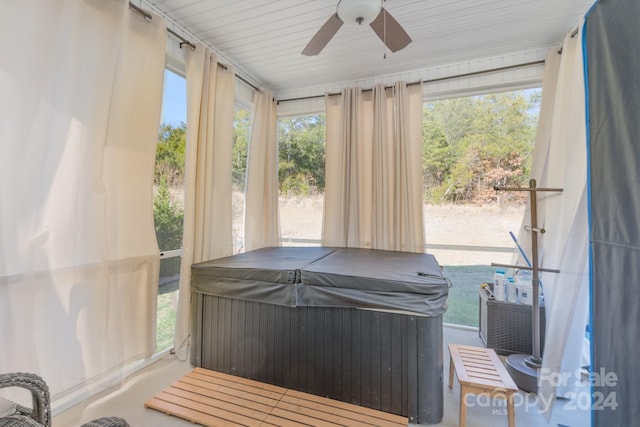 sunroom with a hot tub