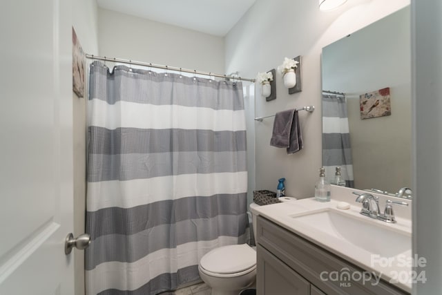 bathroom with a shower with curtain, vanity, and toilet