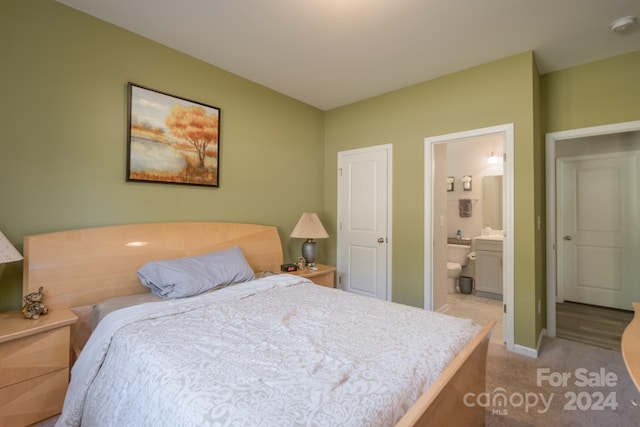 carpeted bedroom featuring ensuite bathroom