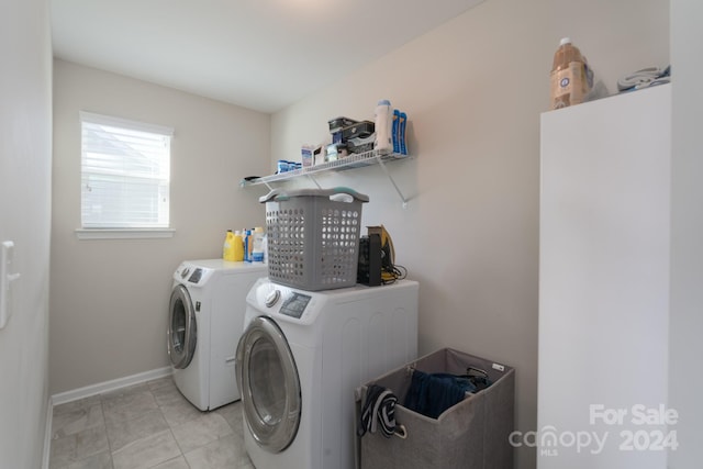 clothes washing area featuring independent washer and dryer and light tile patterned floors