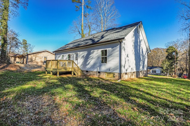 back of property featuring a lawn and a deck