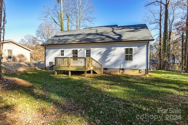 back of house with a lawn and a wooden deck