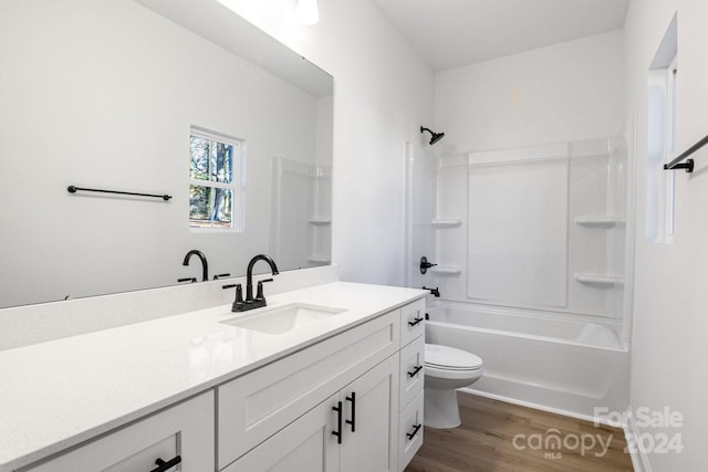 full bathroom featuring bathtub / shower combination, wood-type flooring, vanity, and toilet