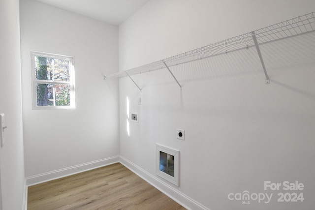 washroom with hookup for an electric dryer, hardwood / wood-style floors, and washer hookup