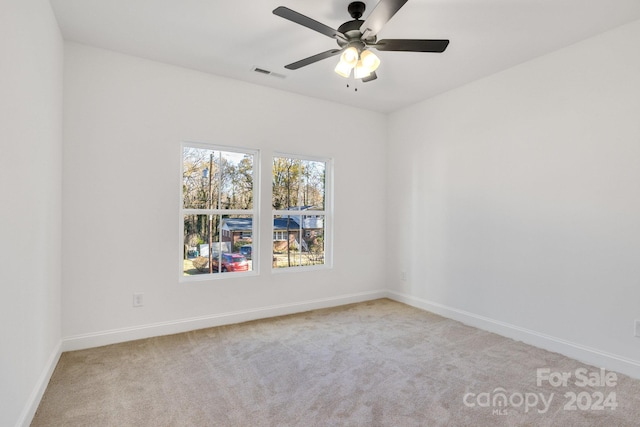 carpeted empty room featuring ceiling fan