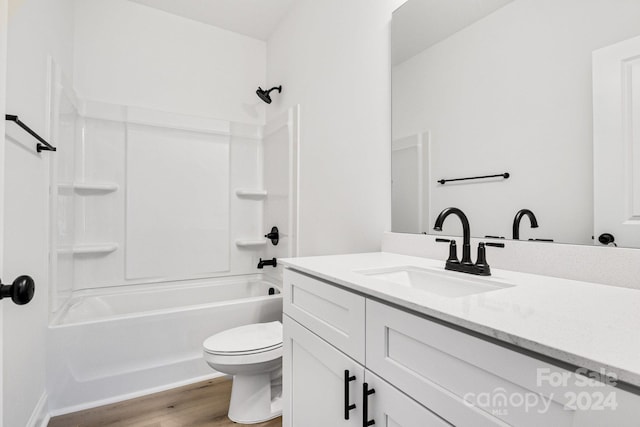 full bathroom with toilet, vanity, shower / bathtub combination, and hardwood / wood-style flooring