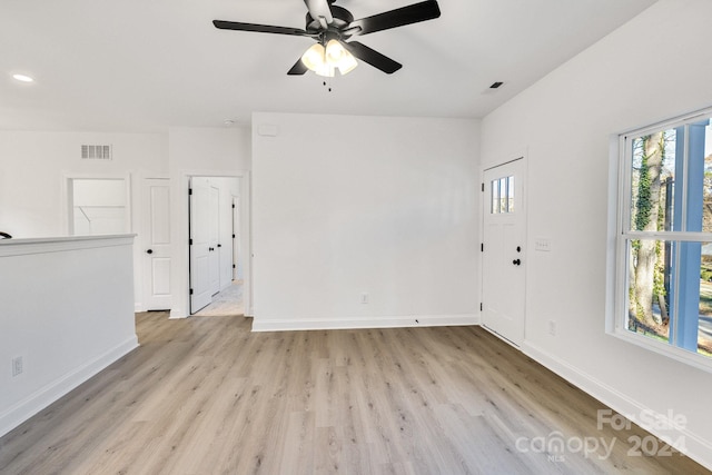 empty room with light wood-type flooring and ceiling fan