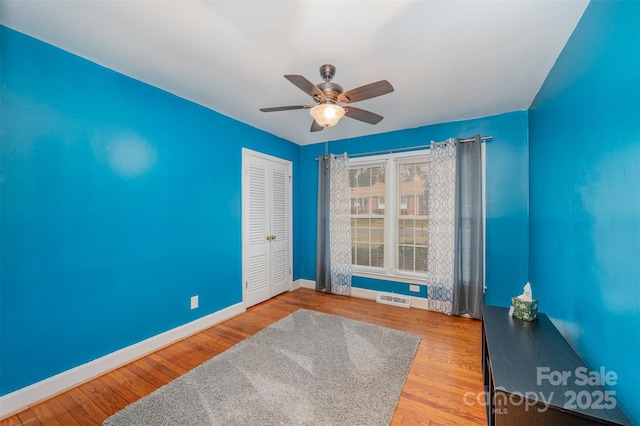 spare room with ceiling fan and hardwood / wood-style floors