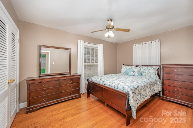 bedroom with ceiling fan, a closet, and light wood-type flooring