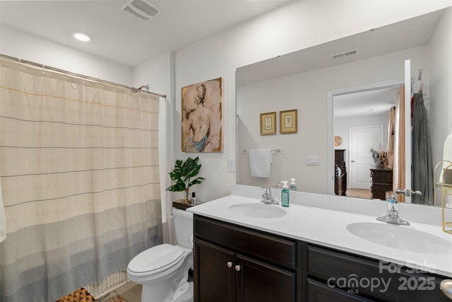 bathroom featuring vanity and toilet