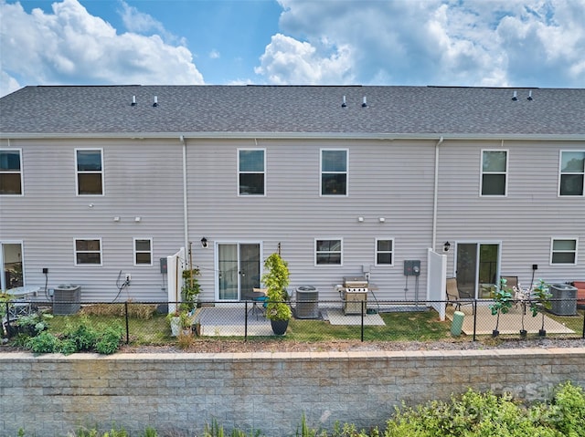 rear view of property featuring central AC