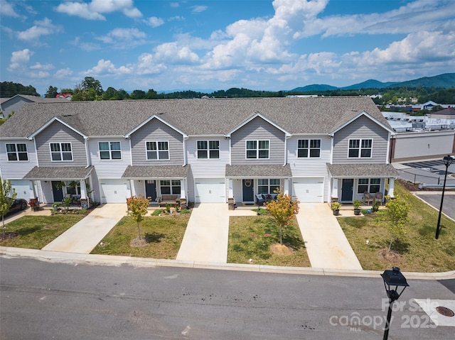 multi unit property featuring a mountain view and a garage