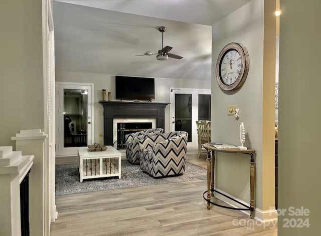 living room featuring ceiling fan and light hardwood / wood-style floors