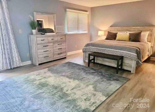 bedroom with hardwood / wood-style flooring