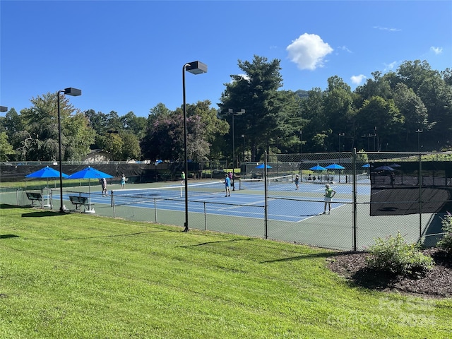 view of sport court featuring a yard