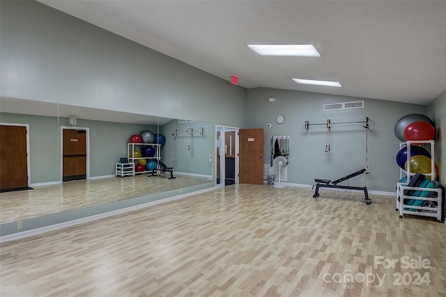 workout area with wood-type flooring and lofted ceiling