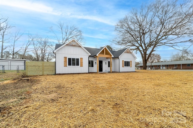 modern farmhouse style home with a front yard