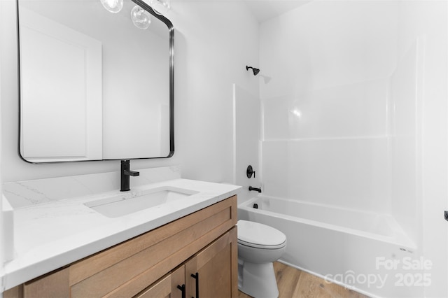 full bathroom featuring vanity, toilet, bathing tub / shower combination, and wood-type flooring