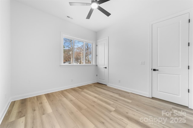 empty room with ceiling fan and light wood-type flooring