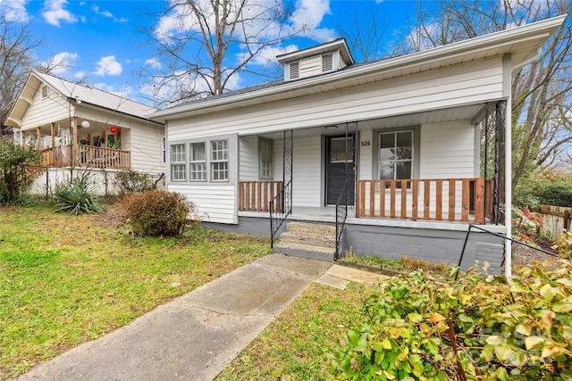 view of front of home featuring covered porch and a front yard