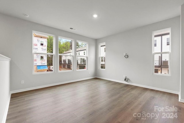 unfurnished room with hardwood / wood-style flooring