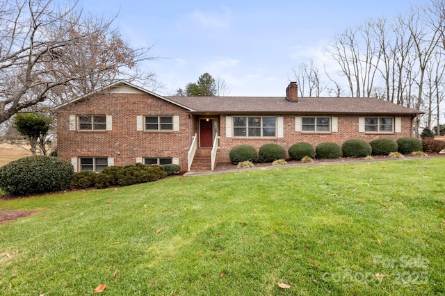 ranch-style house with brick siding, a chimney, and a front lawn