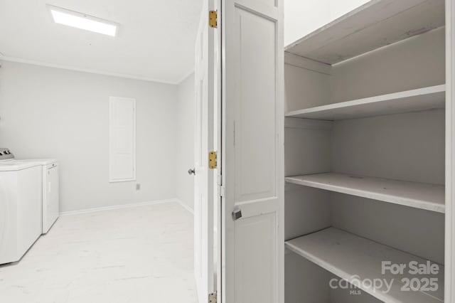 washroom featuring baseboards, laundry area, crown molding, and washer and dryer