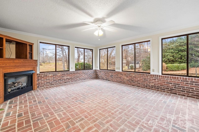 unfurnished sunroom featuring ceiling fan