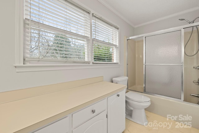 bathroom featuring enclosed tub / shower combo, crown molding, and toilet