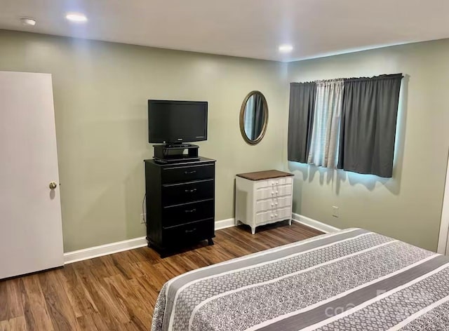 bedroom featuring dark hardwood / wood-style flooring