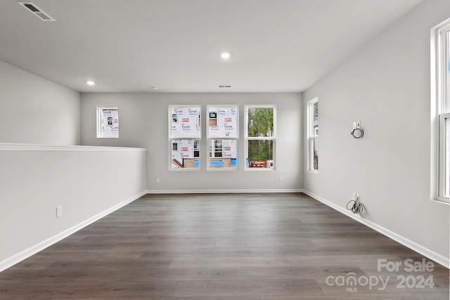 empty room with dark wood-type flooring