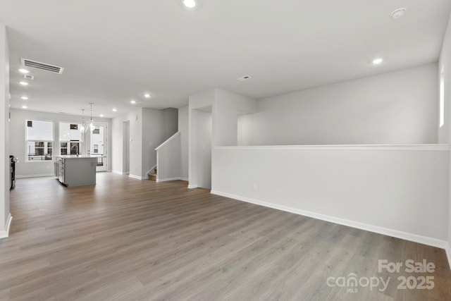 interior space with light hardwood / wood-style flooring and a notable chandelier