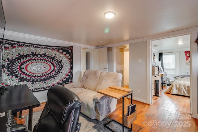 living room with crown molding and light wood-type flooring