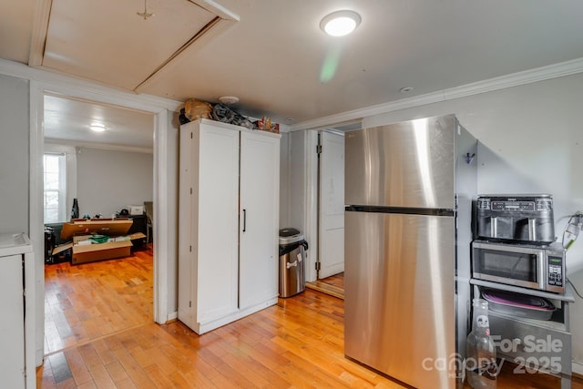 kitchen featuring light hardwood / wood-style flooring, white cabinets, and appliances with stainless steel finishes