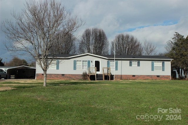 view of front of house with a front yard and a carport