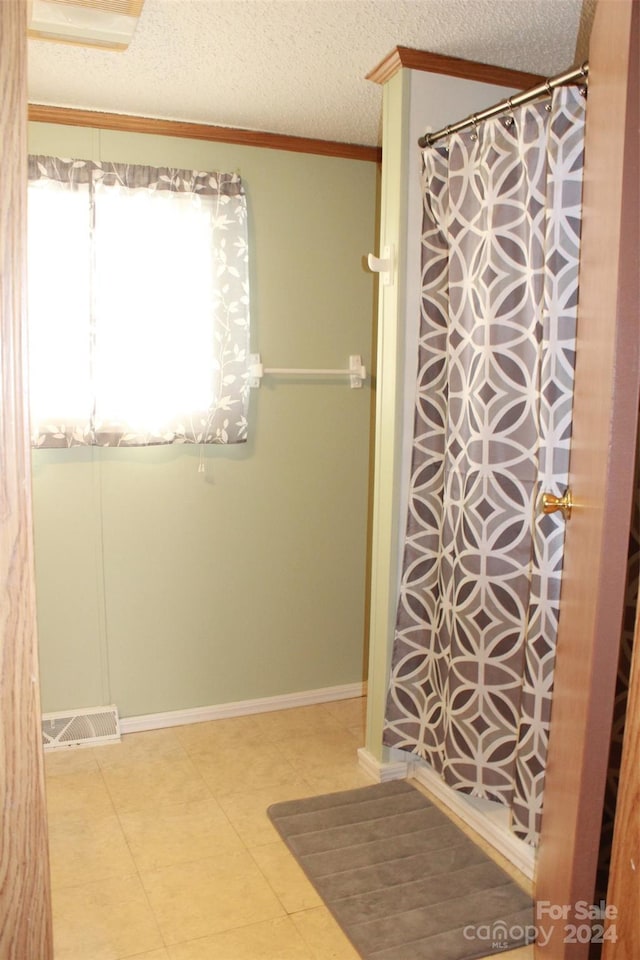 bathroom featuring a textured ceiling and crown molding