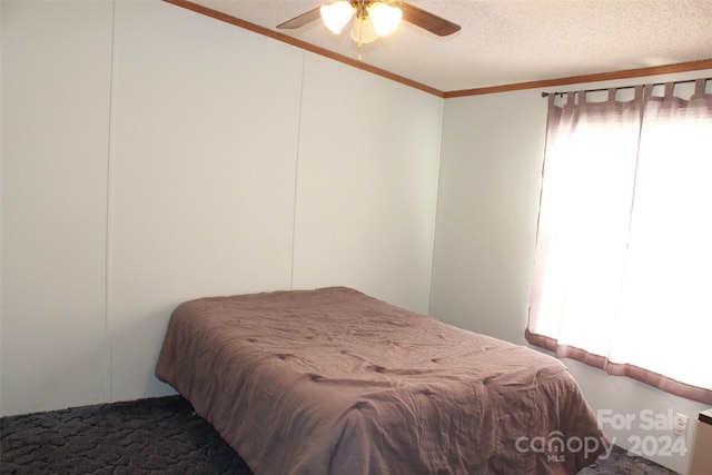 carpeted bedroom with a textured ceiling and ceiling fan