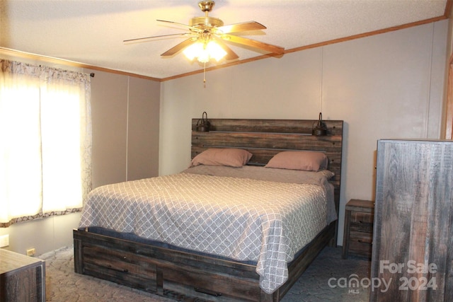 bedroom with a textured ceiling, ceiling fan, carpet floors, and crown molding