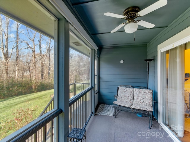 sunroom / solarium featuring ceiling fan