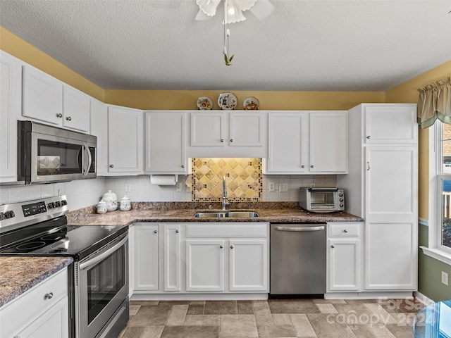 kitchen with sink, white cabinets, and stainless steel appliances