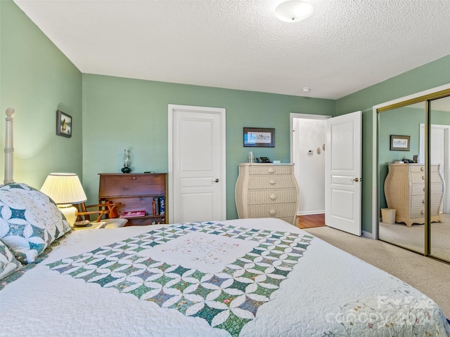 bedroom with carpet floors, a textured ceiling, and a closet