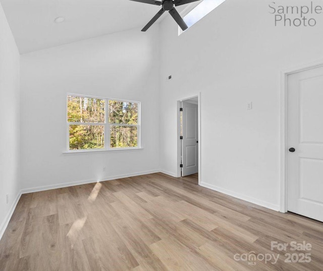 spare room with ceiling fan, light hardwood / wood-style flooring, and high vaulted ceiling