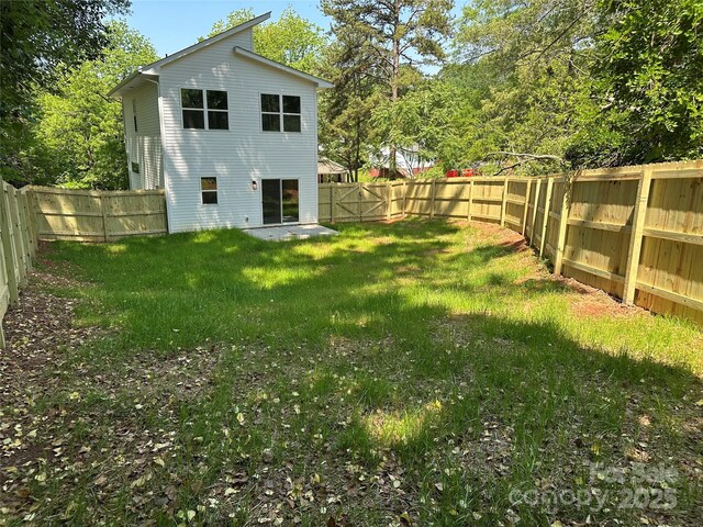 211 Chestnut St, Shelby, NC 28150 - rear view of house with a lawn and a fenced backyard