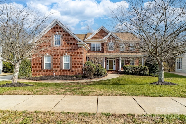 view of front facade featuring a front yard and covered porch