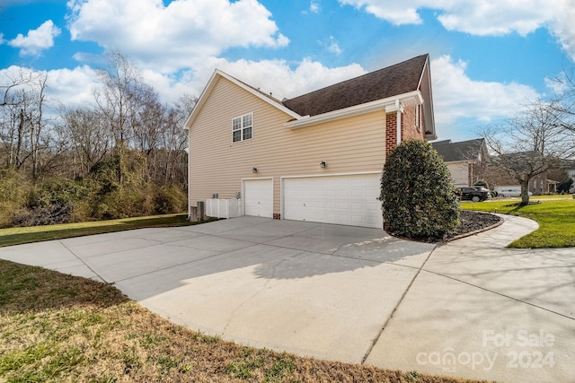 view of property exterior featuring central AC and a garage